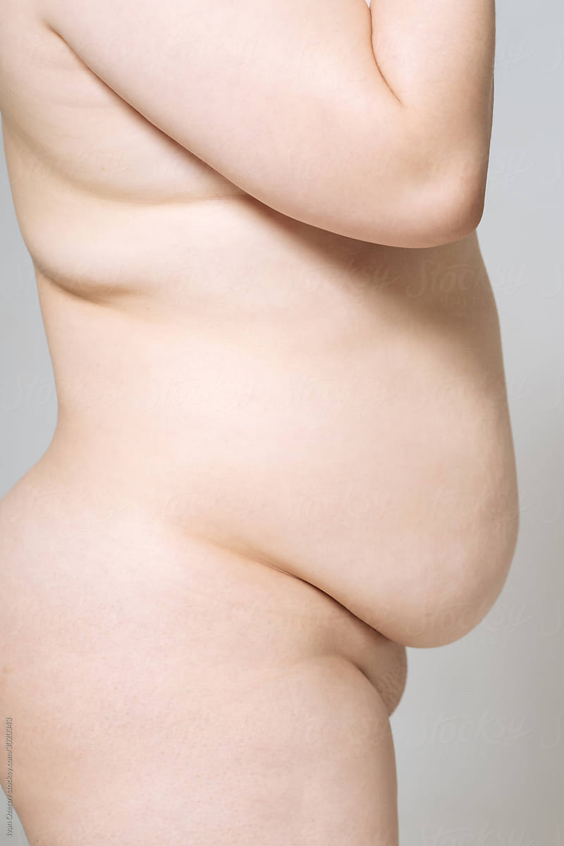 cropped image. Side view of a nude model plus size.
