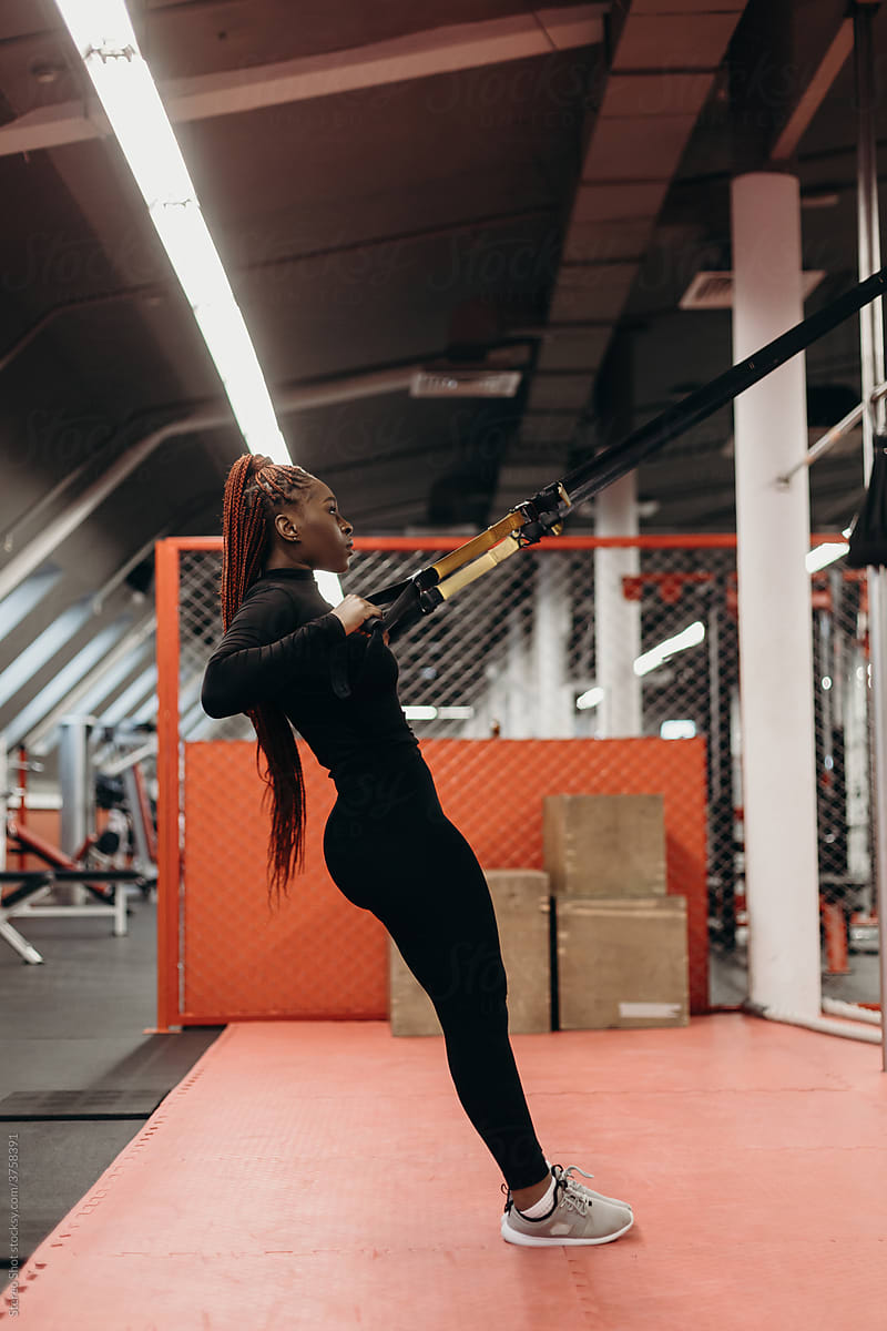Athletic Woman Doing Exercises On TRX Straps by Stocksy Contributor  Stereo Shot - Stocksy