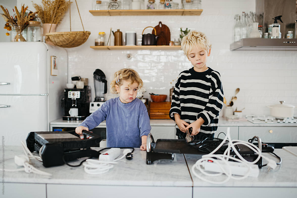 Children making merry with electronic devices at home