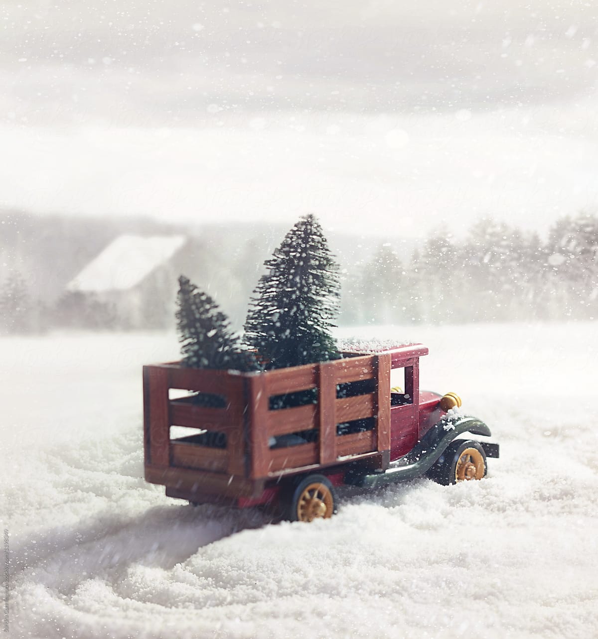 Small toy truck with trees in snow storm