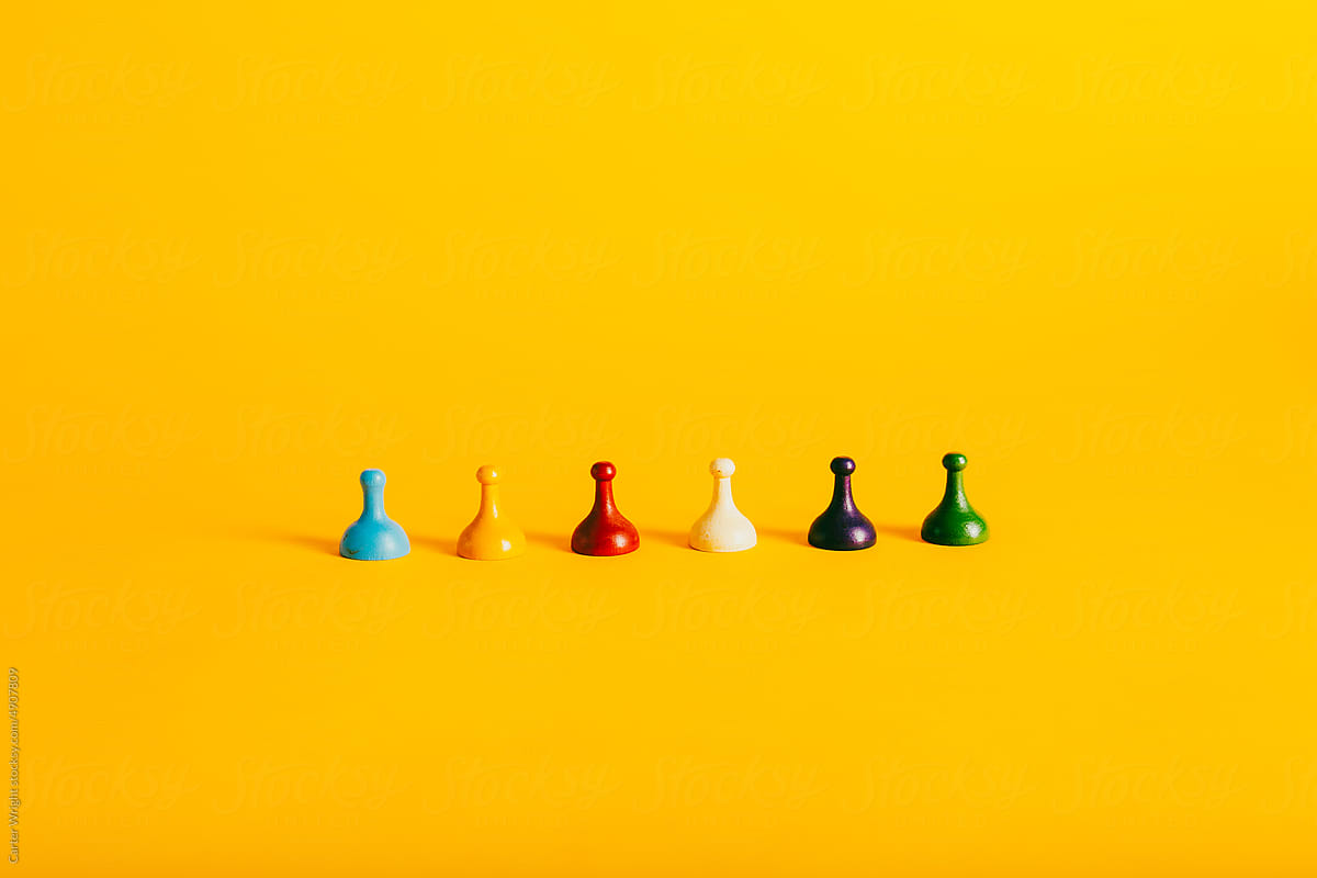 Colorful Board Game pieces on a vibrant yellow background