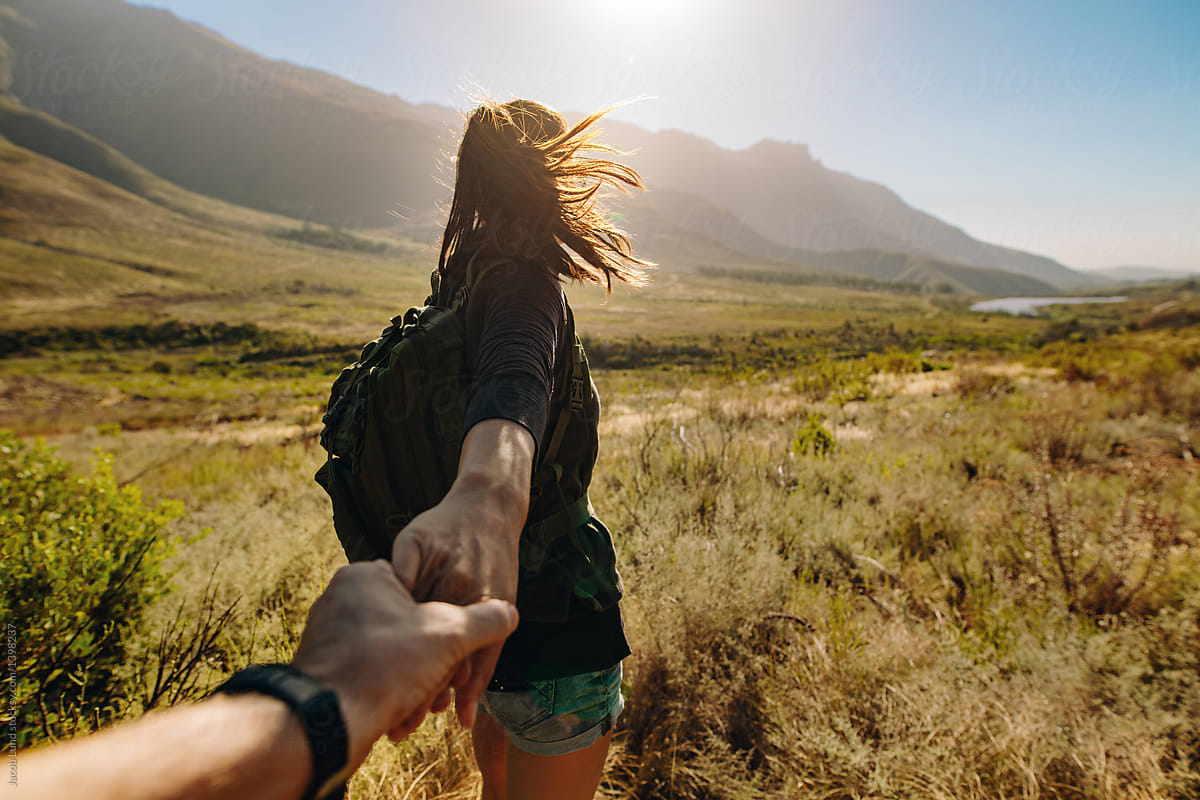 Woman Holding Mans Hand And Leading Him On Hiking Trail By Stocksy Contributor Jacob Lund