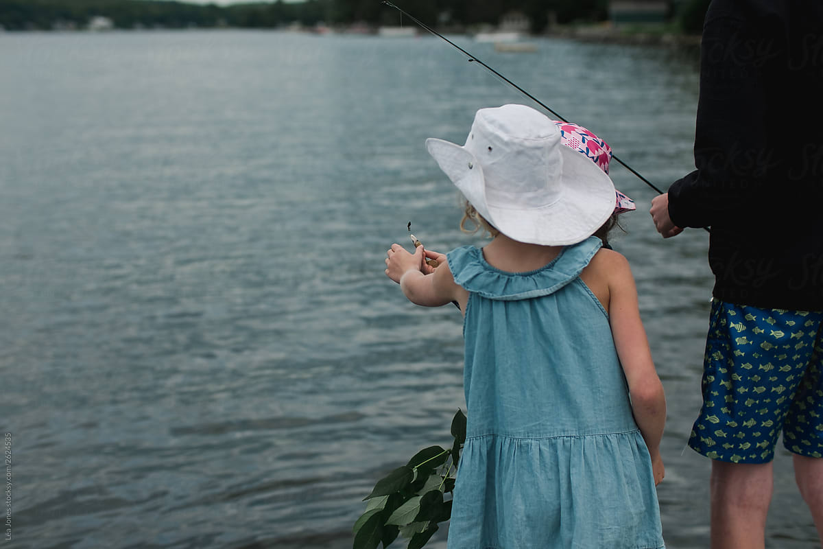 Little Girl With Cowboy Hat Looking At Fishing Lure by Stocksy