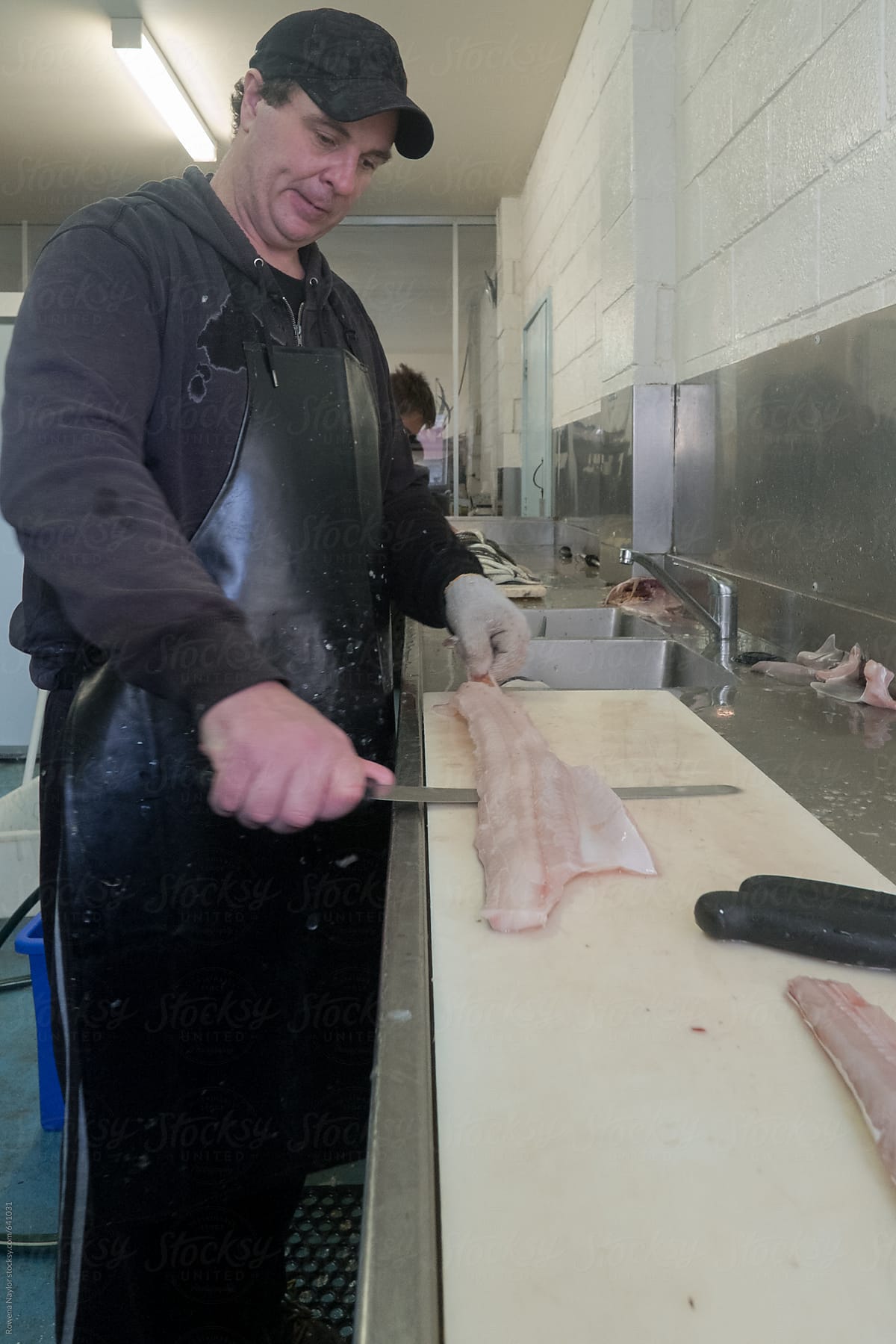 Fishmonger filleting fish
