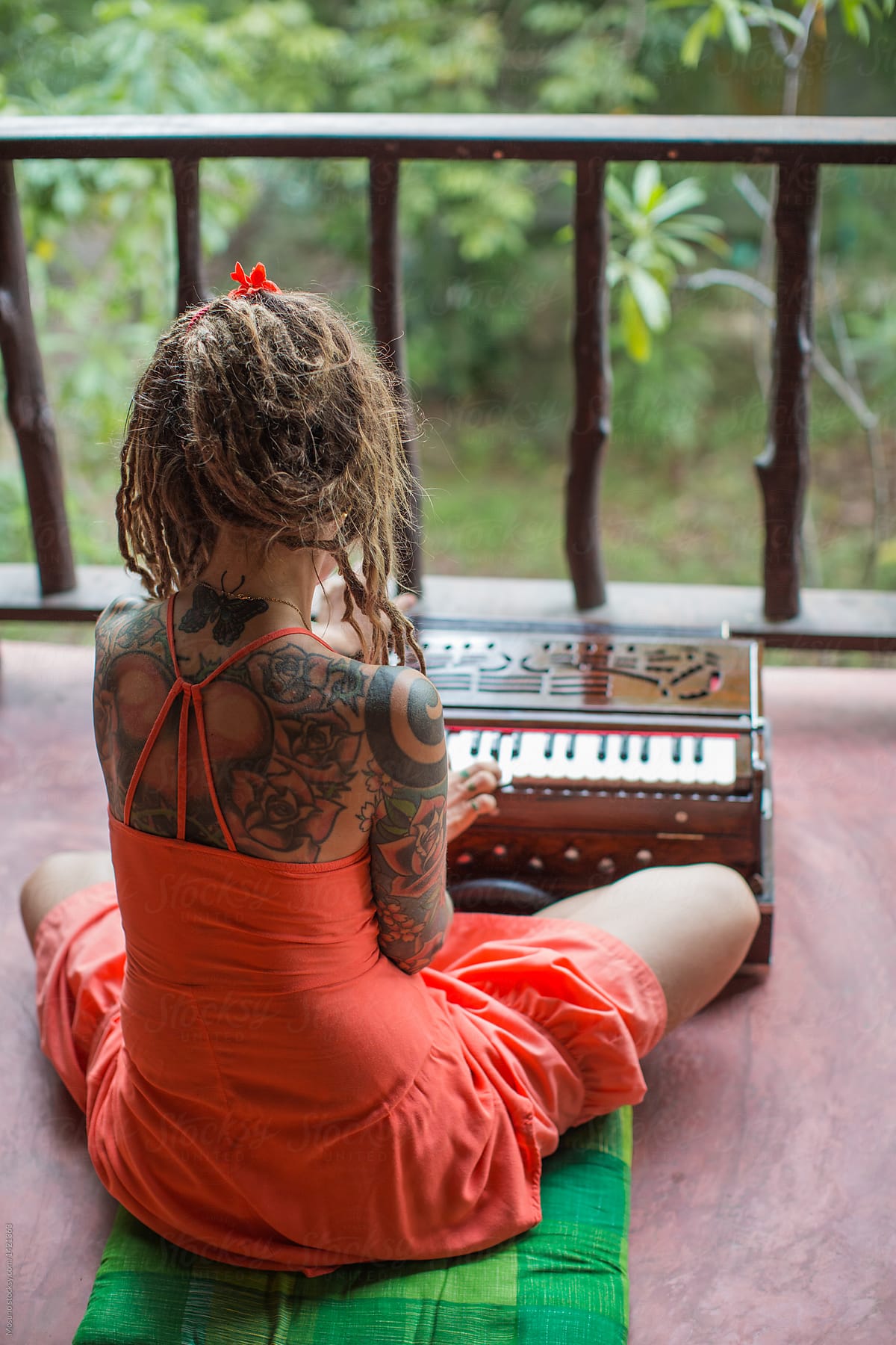 Urban Woman Playing An Instrument On A Tropical Terrace Del Colaborador De Stocksy Mosuno 2108