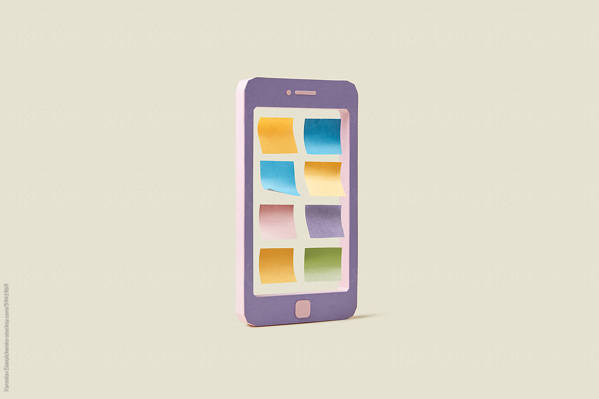 Smartphone covered with colourful sticky notes isolated in studio