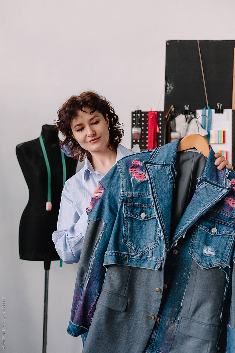 Stylish female designer showing upcycled denim jacket