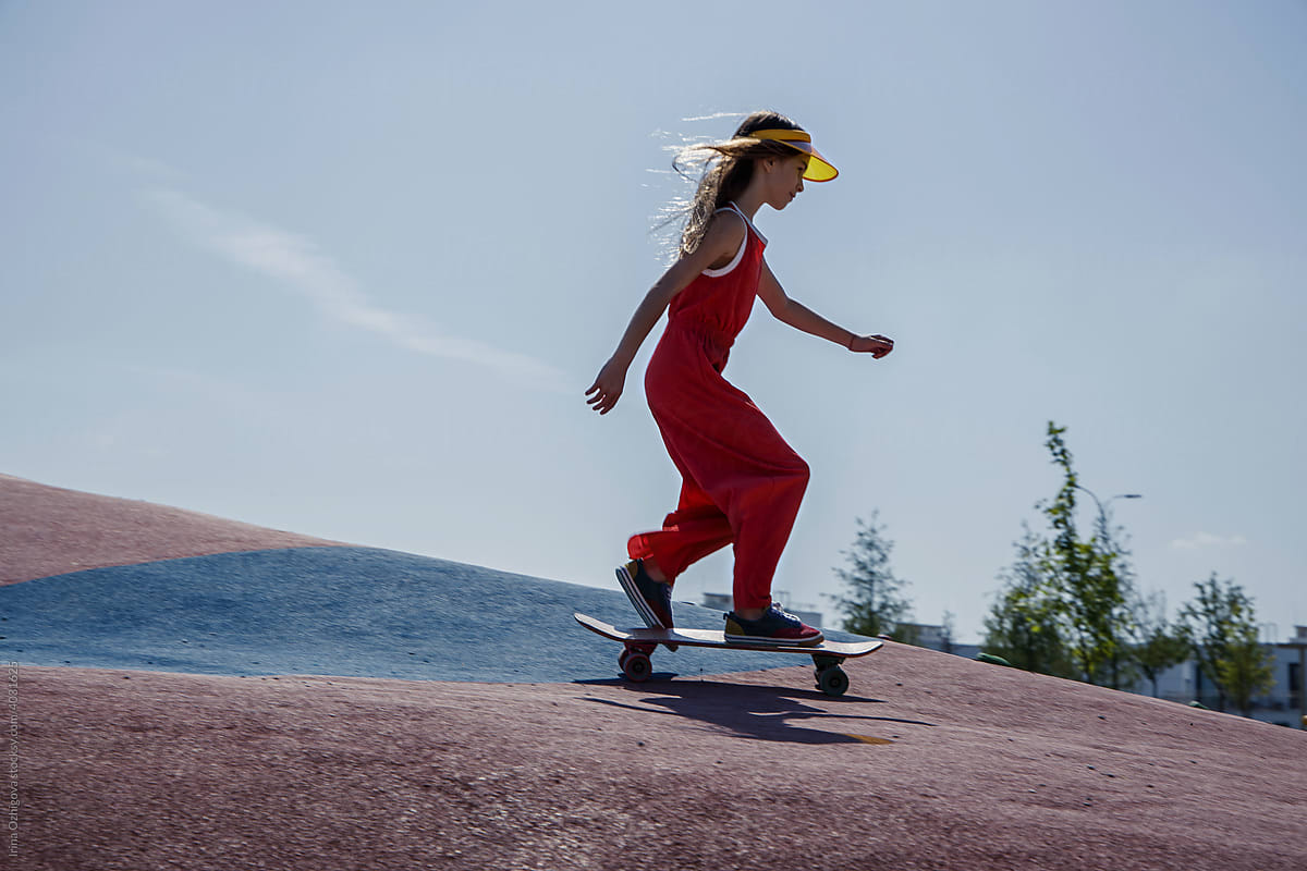 Girl riding skateboard on a hill