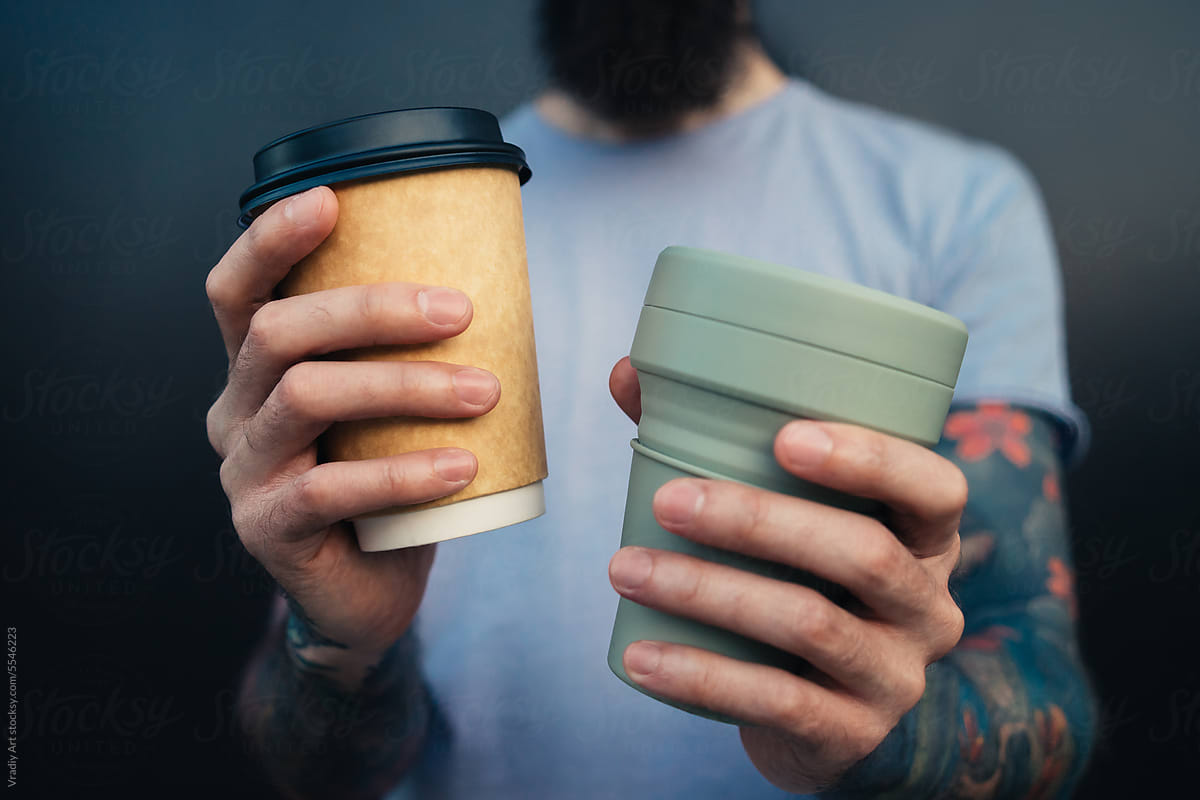 Man with two different coffee cups