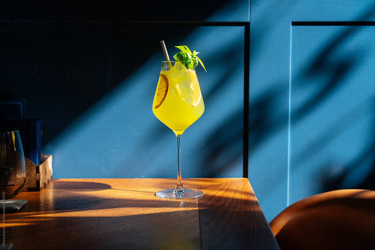 Tasty lemon drink in sunlight on table