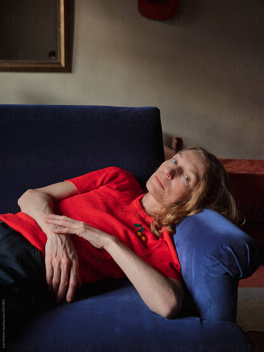 Mature woman lying on sofa