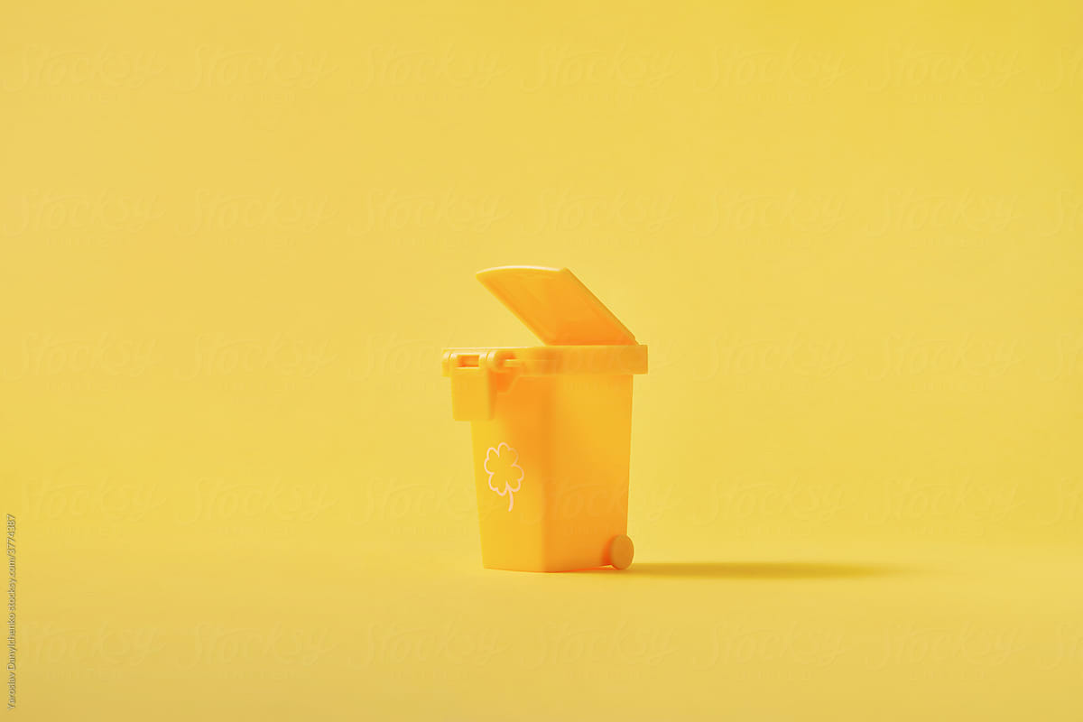 Small open yellow trash can for recycling