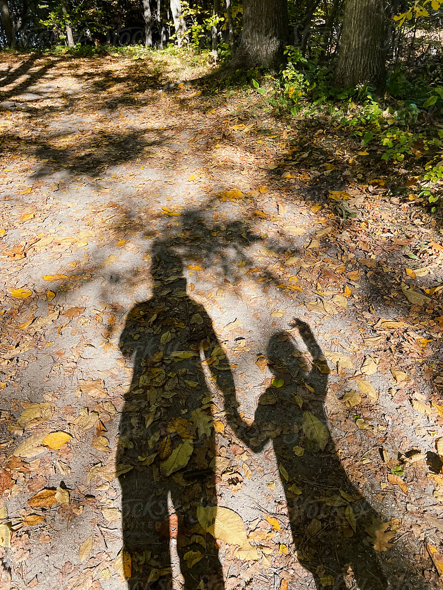 Shadow Selfie of Mother and Child Walking in the Woods