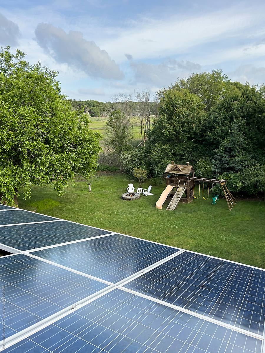 Solar Panels on House roof view to backyard  with outdoor swing set