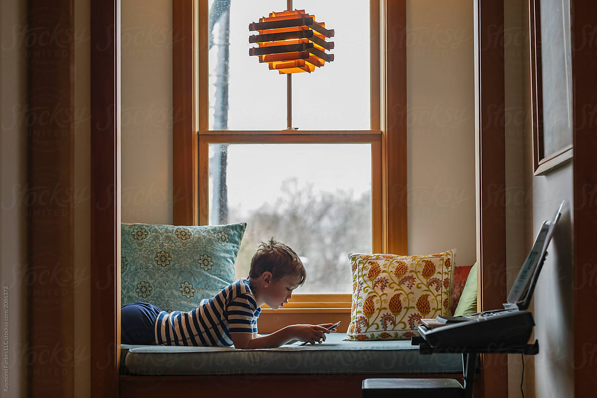 Boy at Home playing on Ipad Tablet Computer