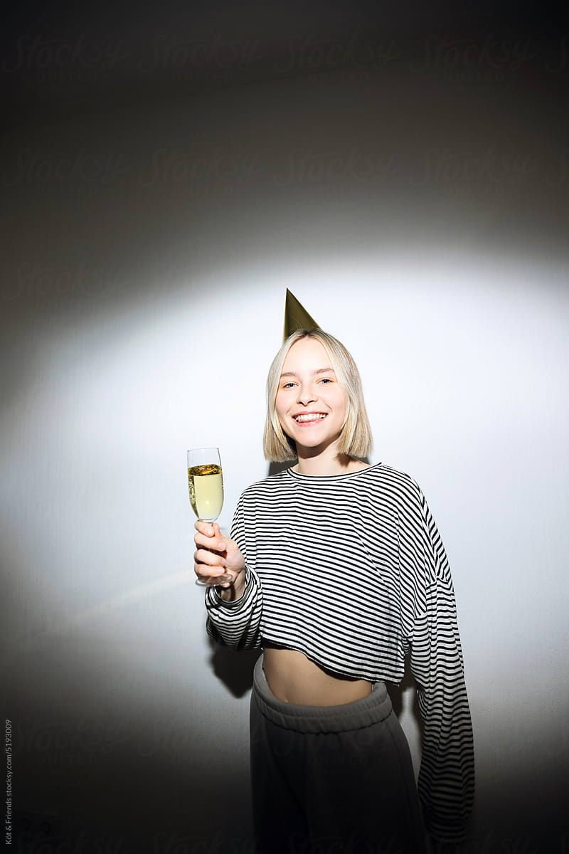 Flash Portrait Of Young Woman In A Party Hat