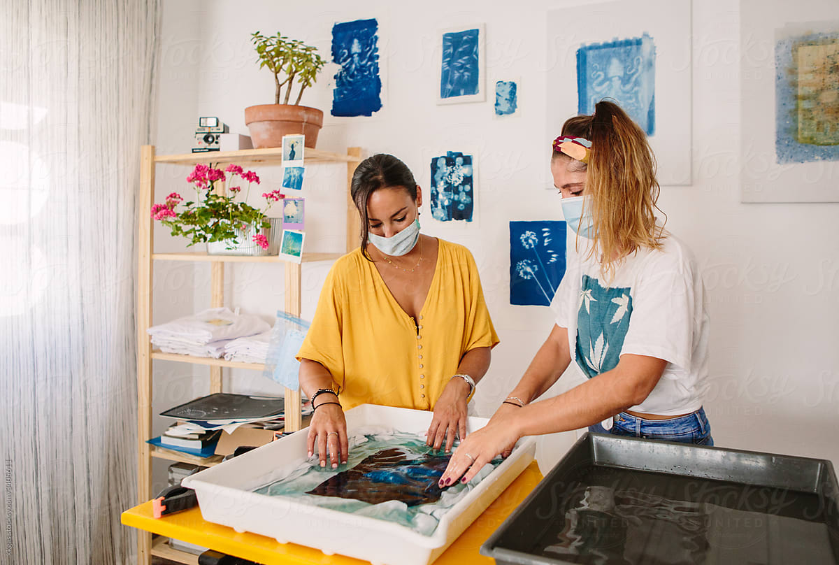 Two friends dyeing a T-shirt