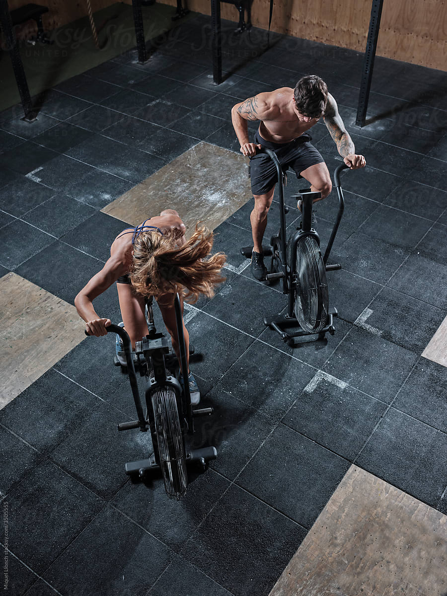 Above view of two airbike athletes in action in a gym