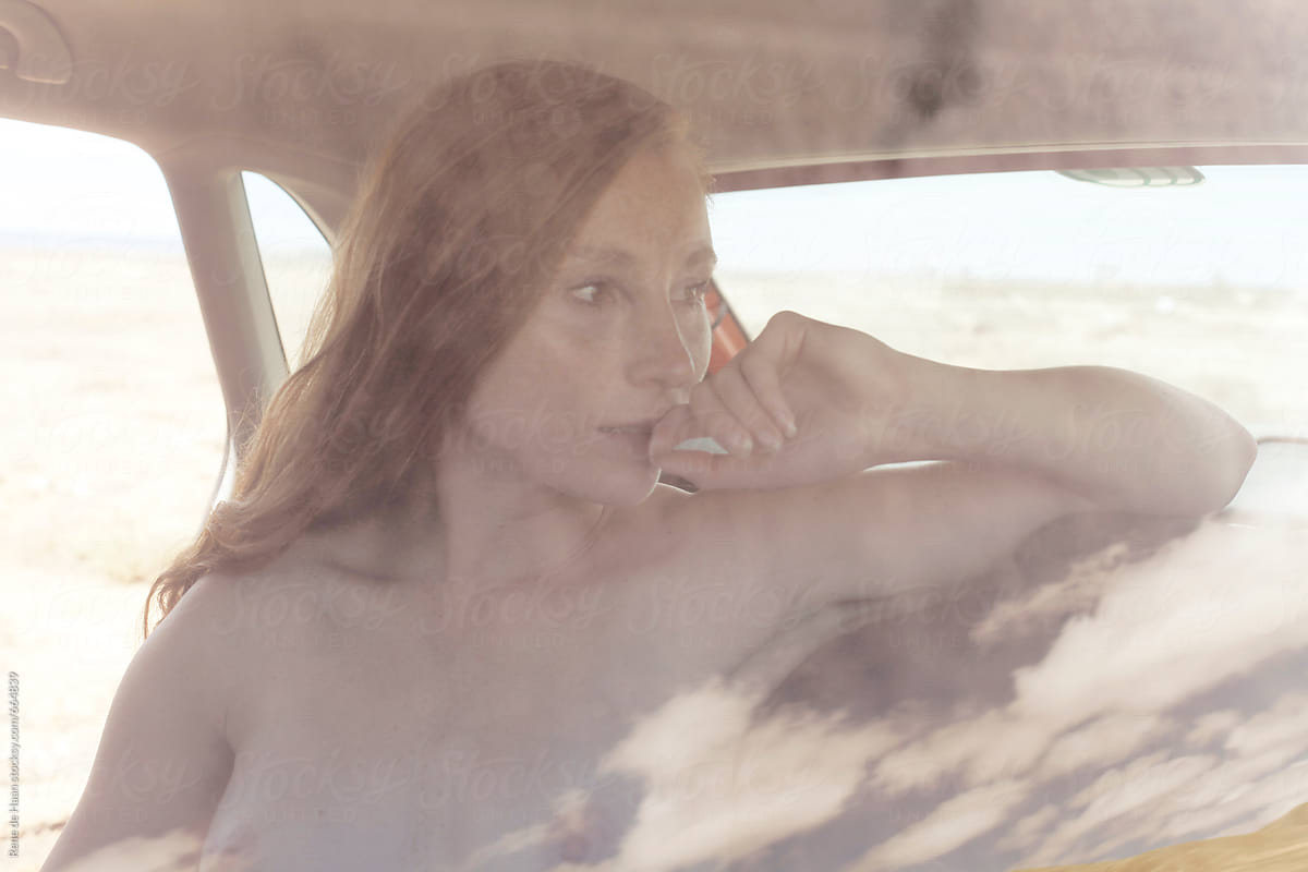 young woman sitting in a car