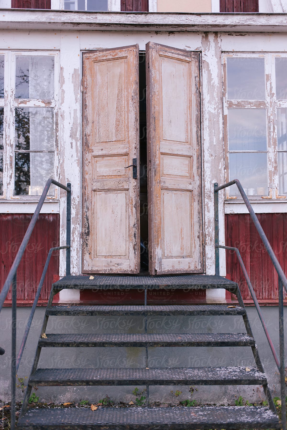 A stair to an old red house.