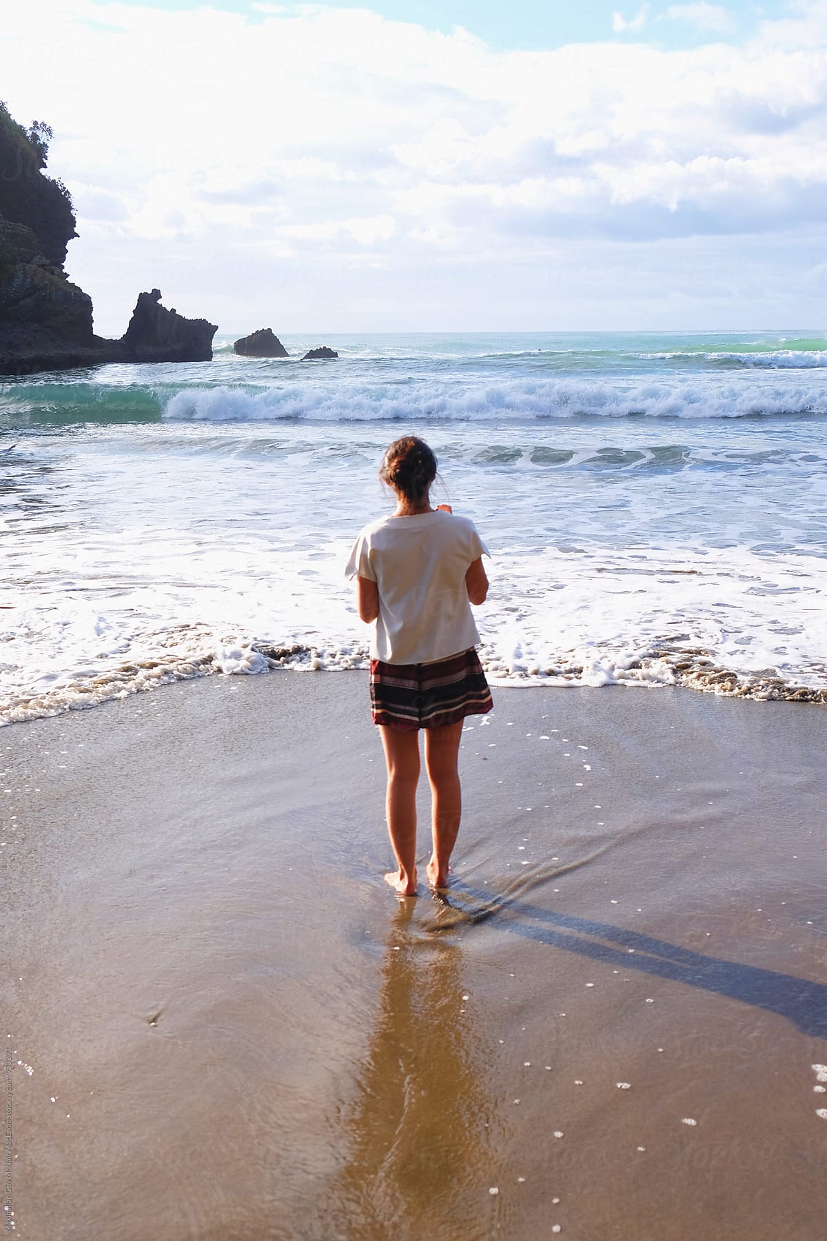Girl standing on the seashore