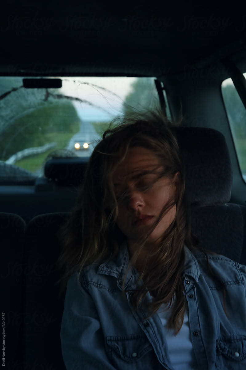 Female passenger sleeping during road trip