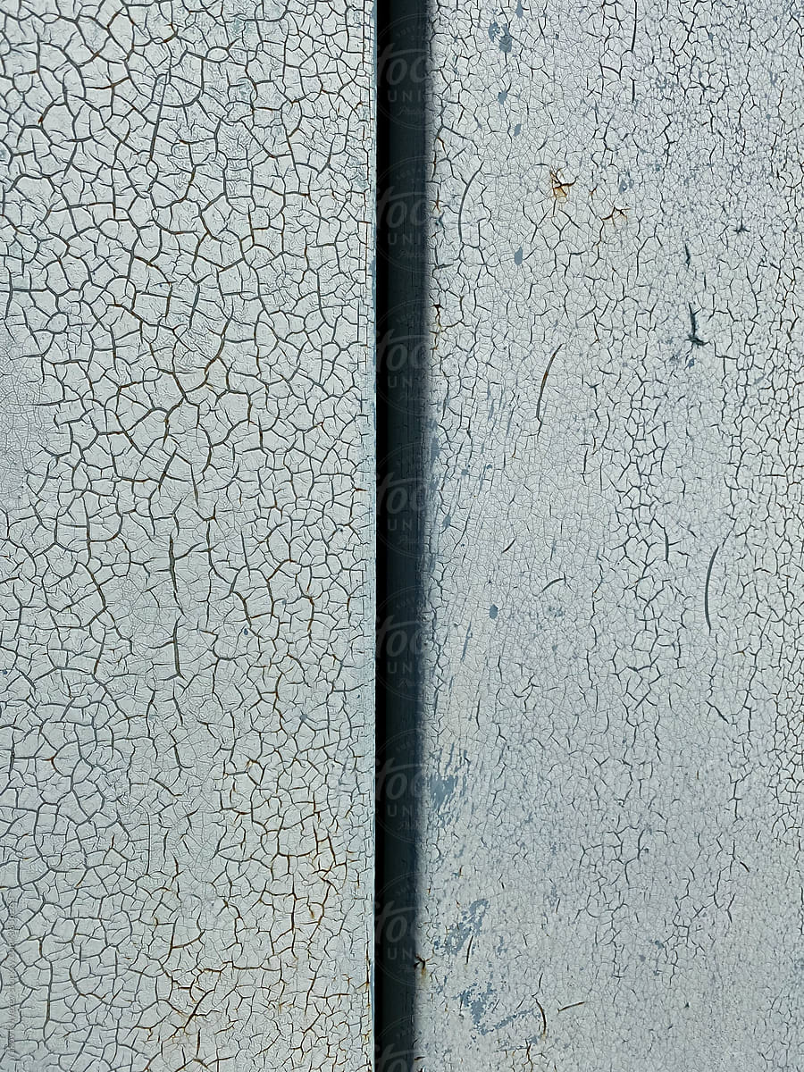 Close-up of a cracked surface. Blue-gray painting
