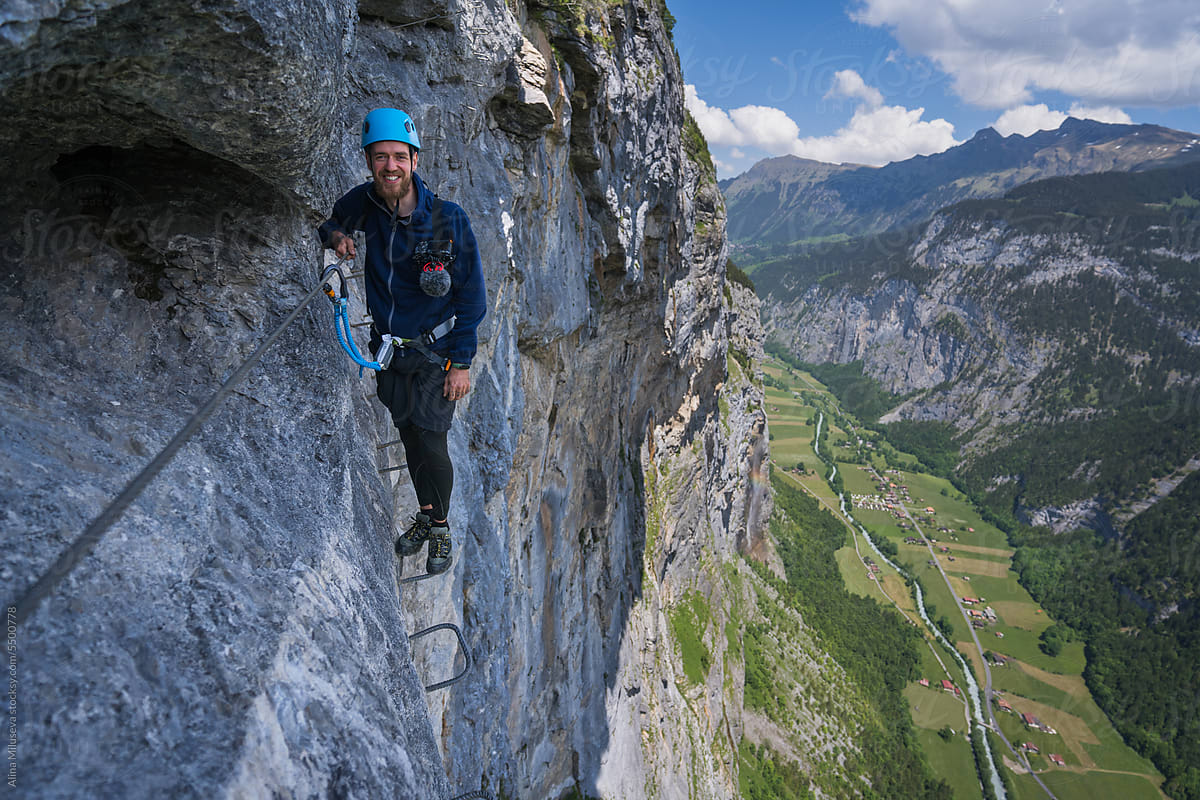 Smiling Explorer Climbing Via Ferrata