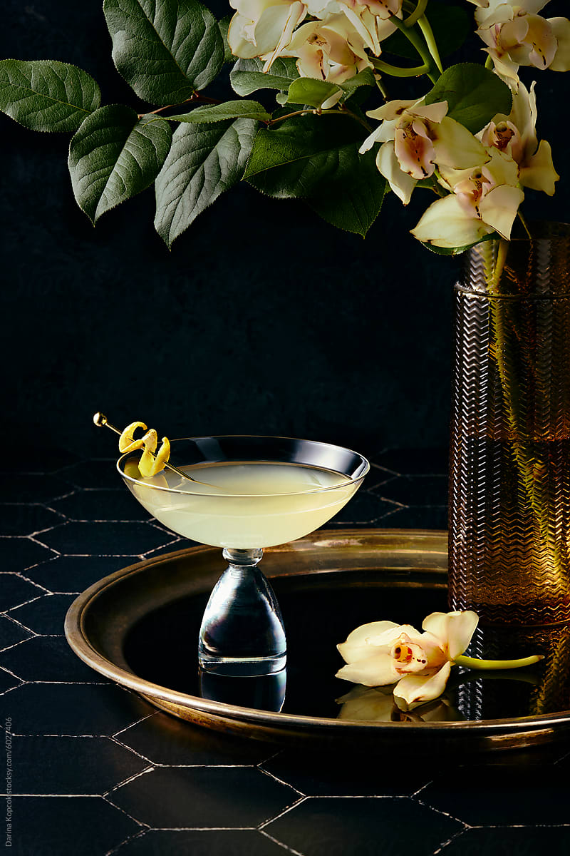 lemon drop martini on a brass tray with flowers