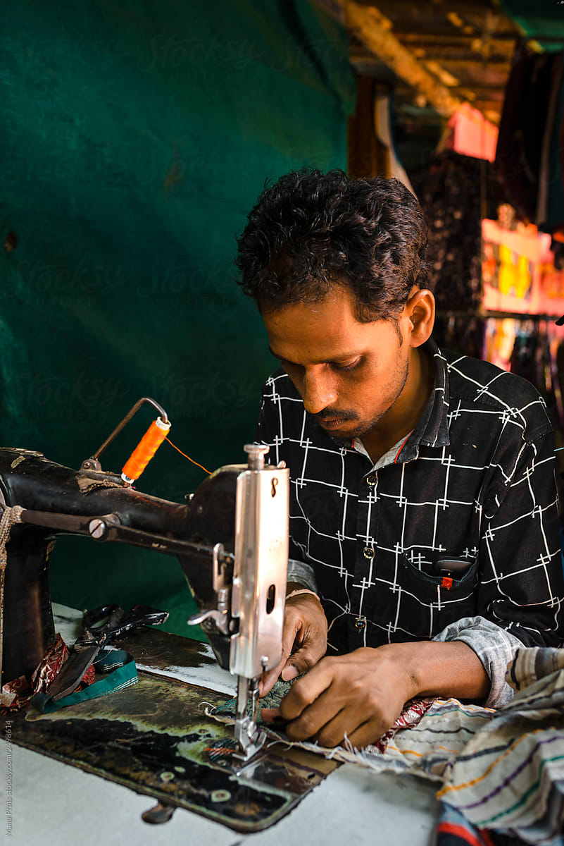Ethnic craftsman sewing bag in workshop