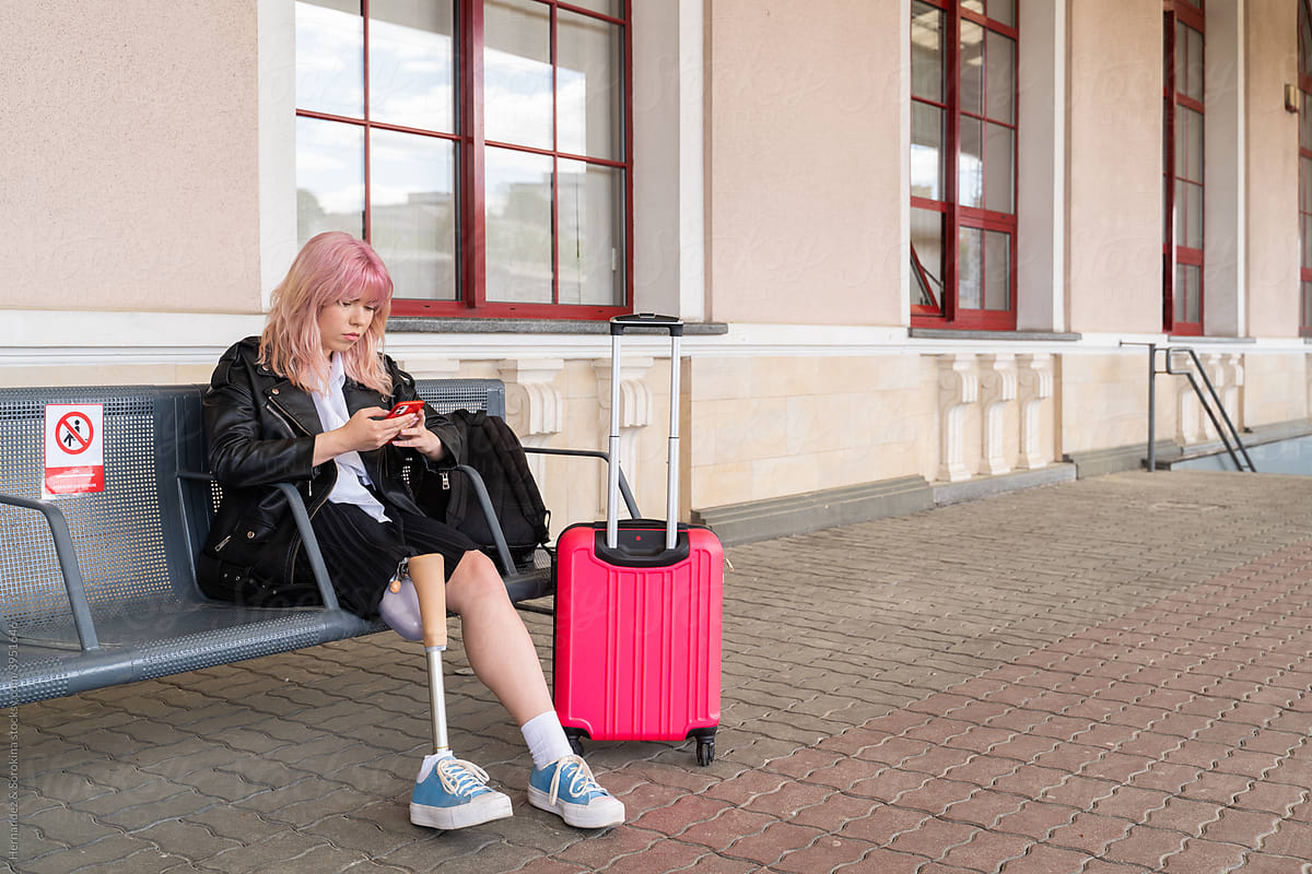 Traveler With Leg Prosthesis Using Cellphone
