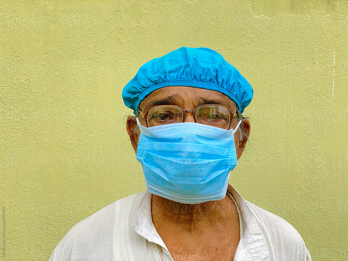 Senior Citizen Wearing Double Mask And Cap