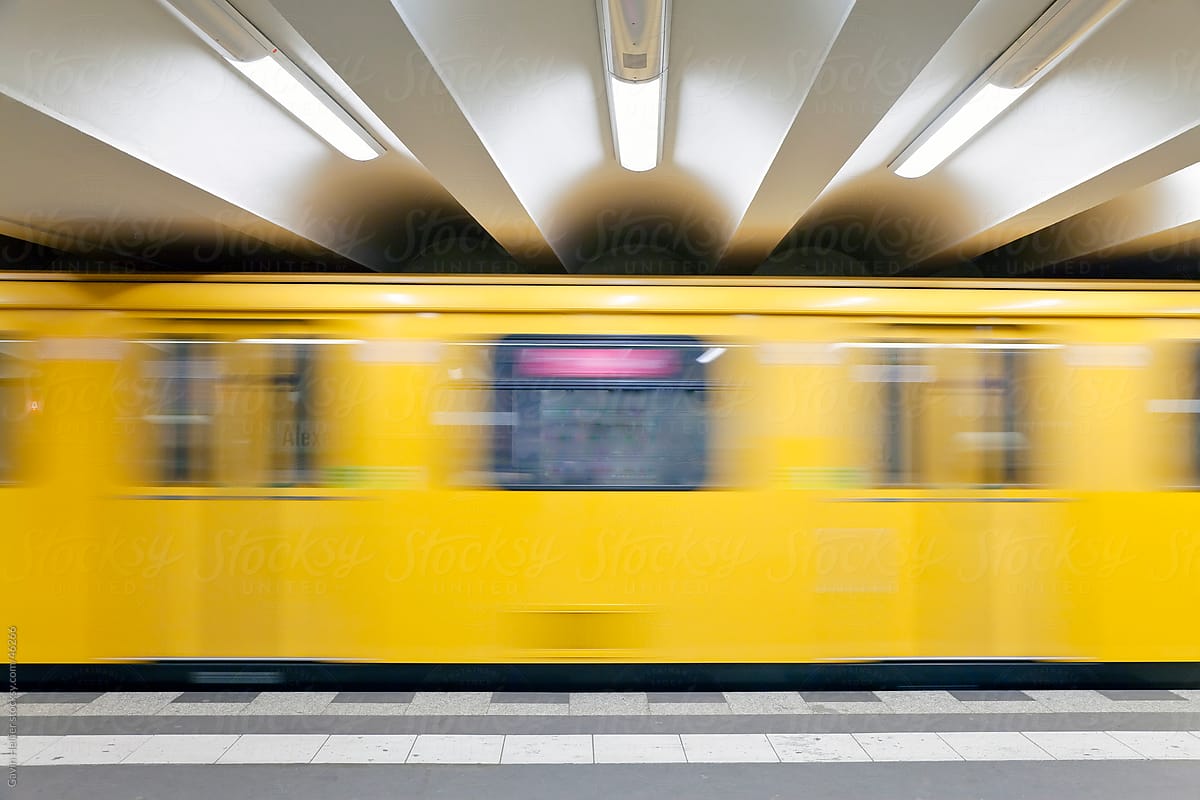 Europe, Germany, Berlin, modern subway station  - moving train pulling into the station