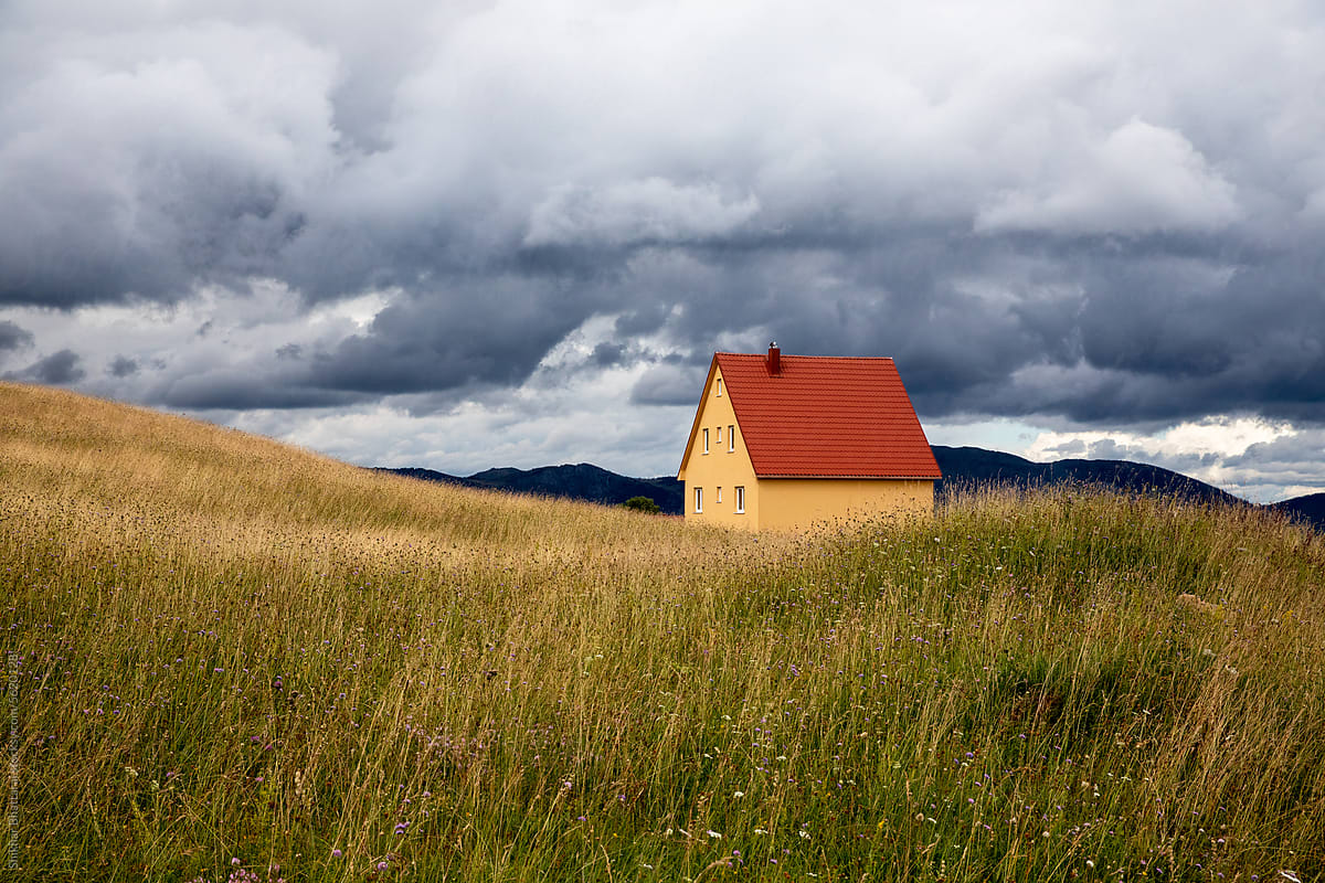 Scenic image of a house in a grassy field.