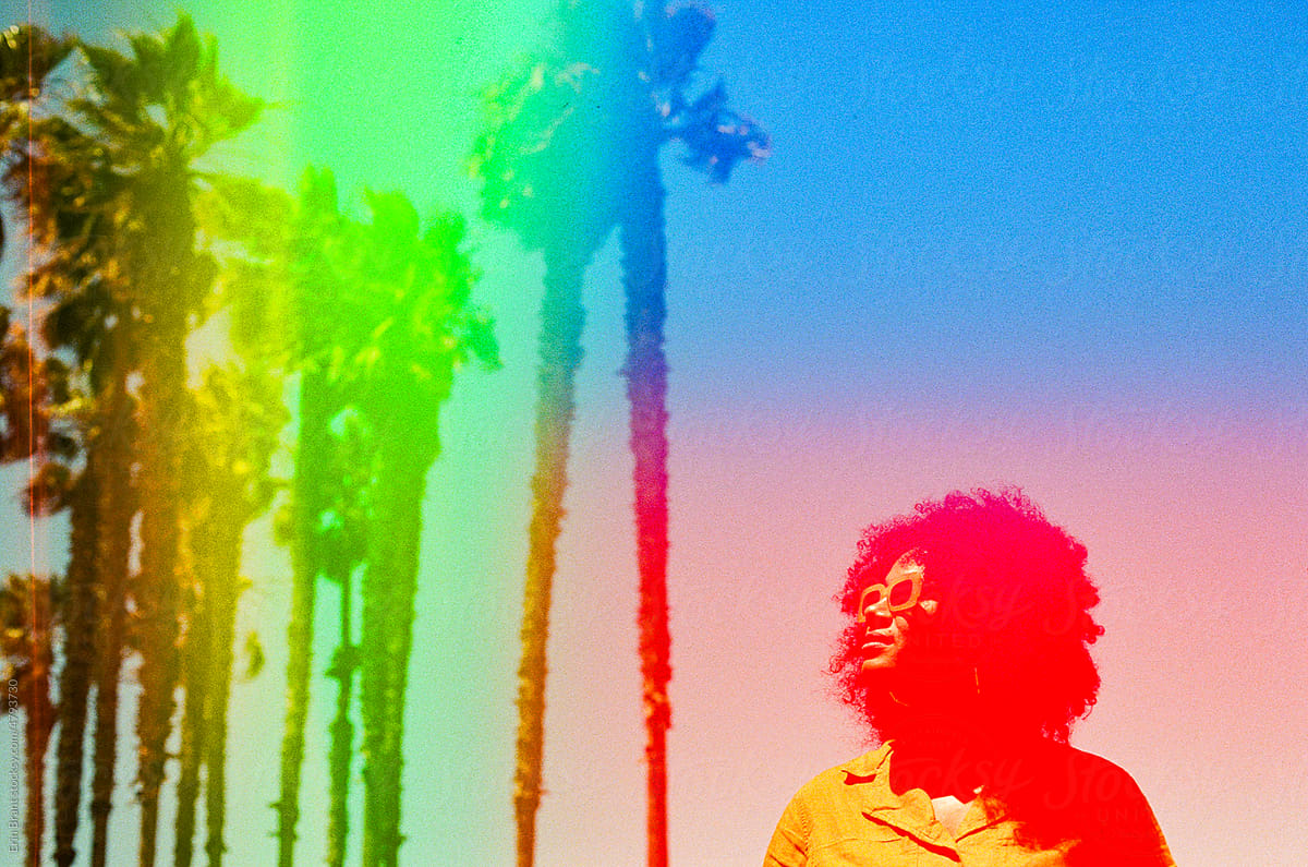 Rainbow palm tree portrait of woman by Erin Brant for Stocksy United