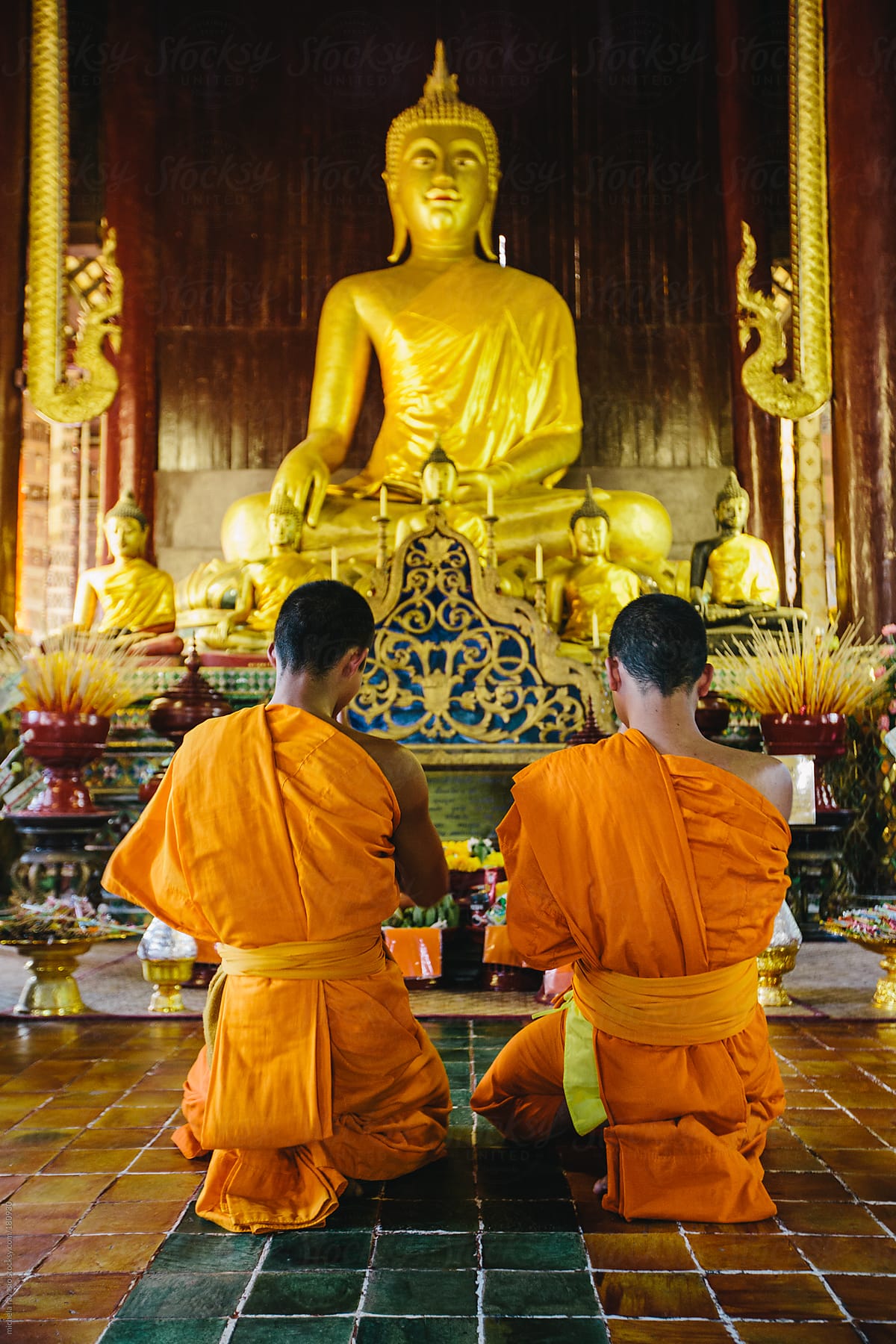 Two Buddhist Monks Praying In The Temple by Michela Ravasio