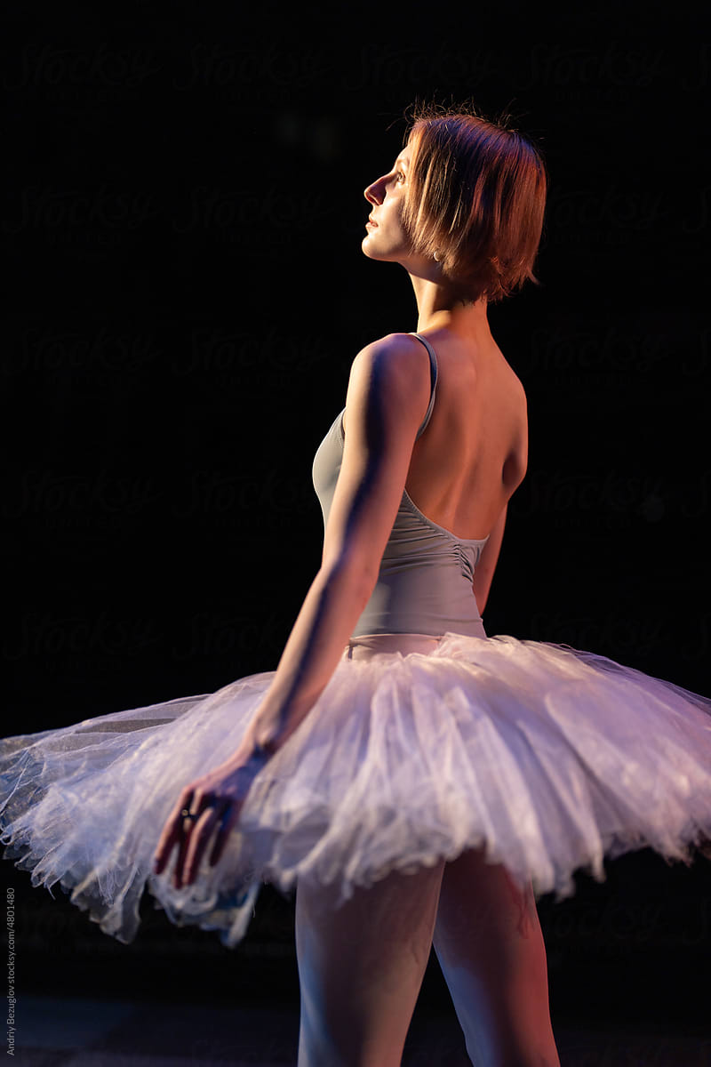 Ballerina standing in studio class in front of the camera in position