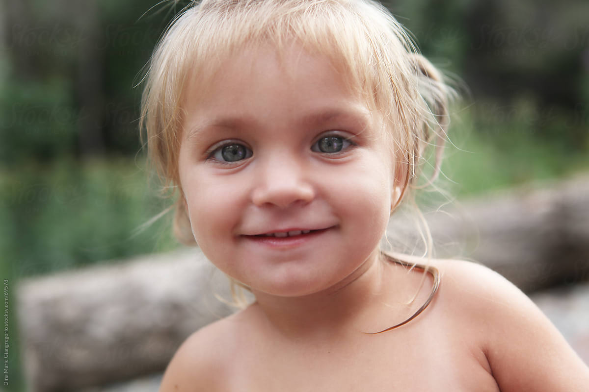 Green Eyeds Blonde Hair And Olive Skinned Girl Toddler Smiling