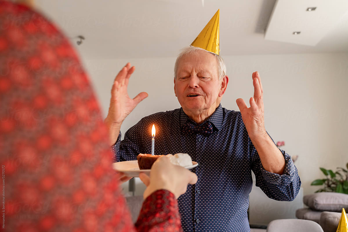 Senior Man Is Going To Blow Out Birthday Candle