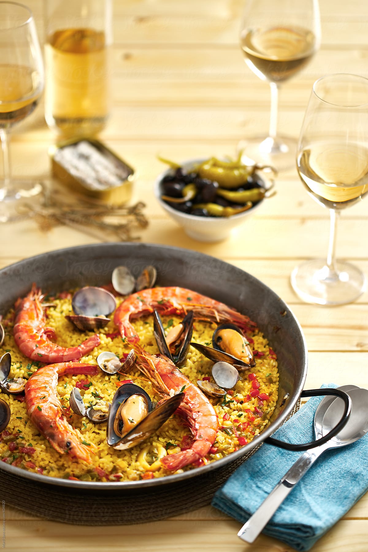 Spanish paella meal and white wine