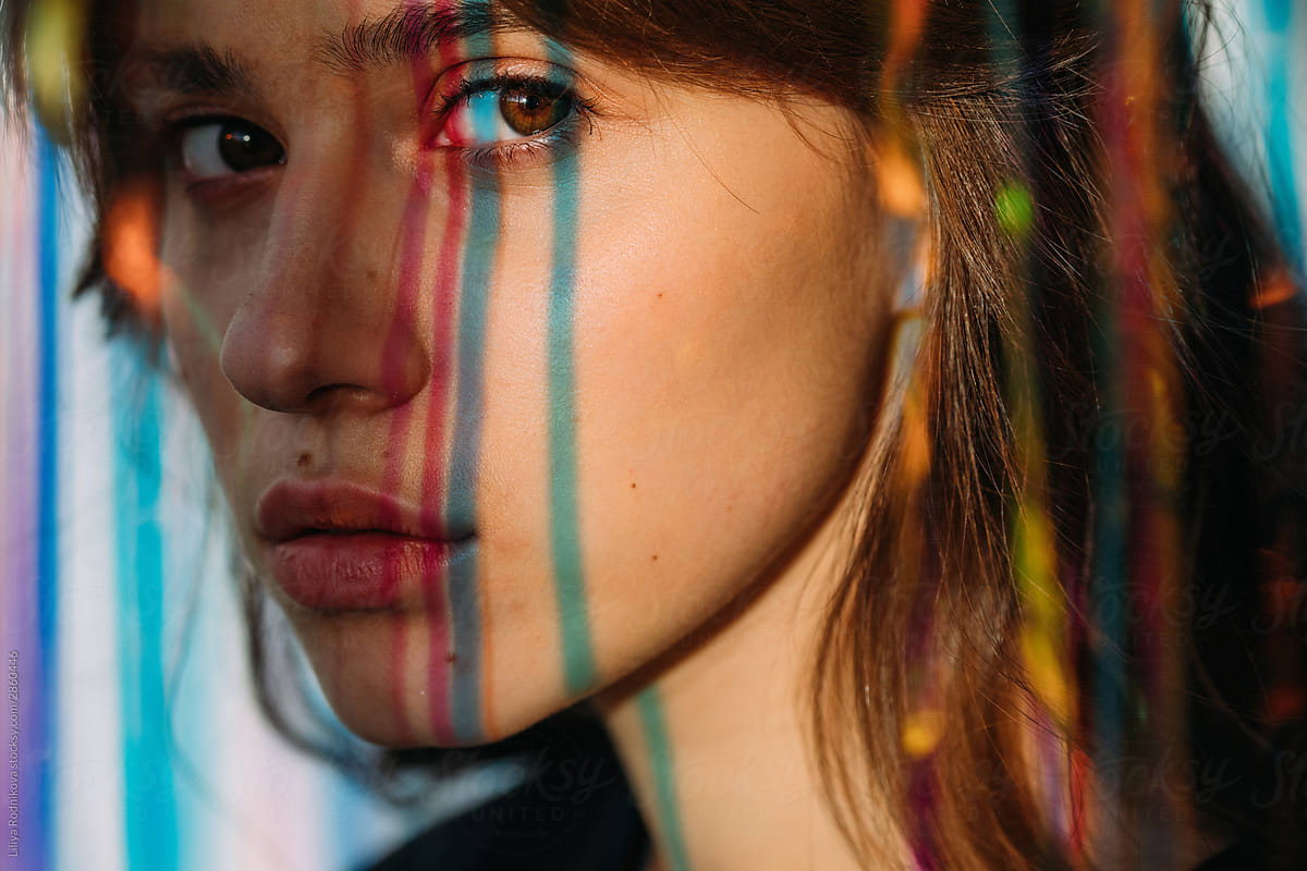 Colorful light  lines on face of beautiful girl