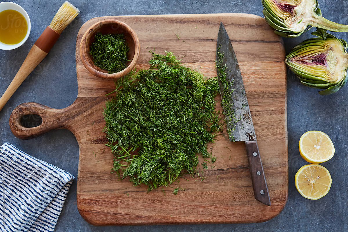 Overhead shot of Chopped herbs on a cutting board