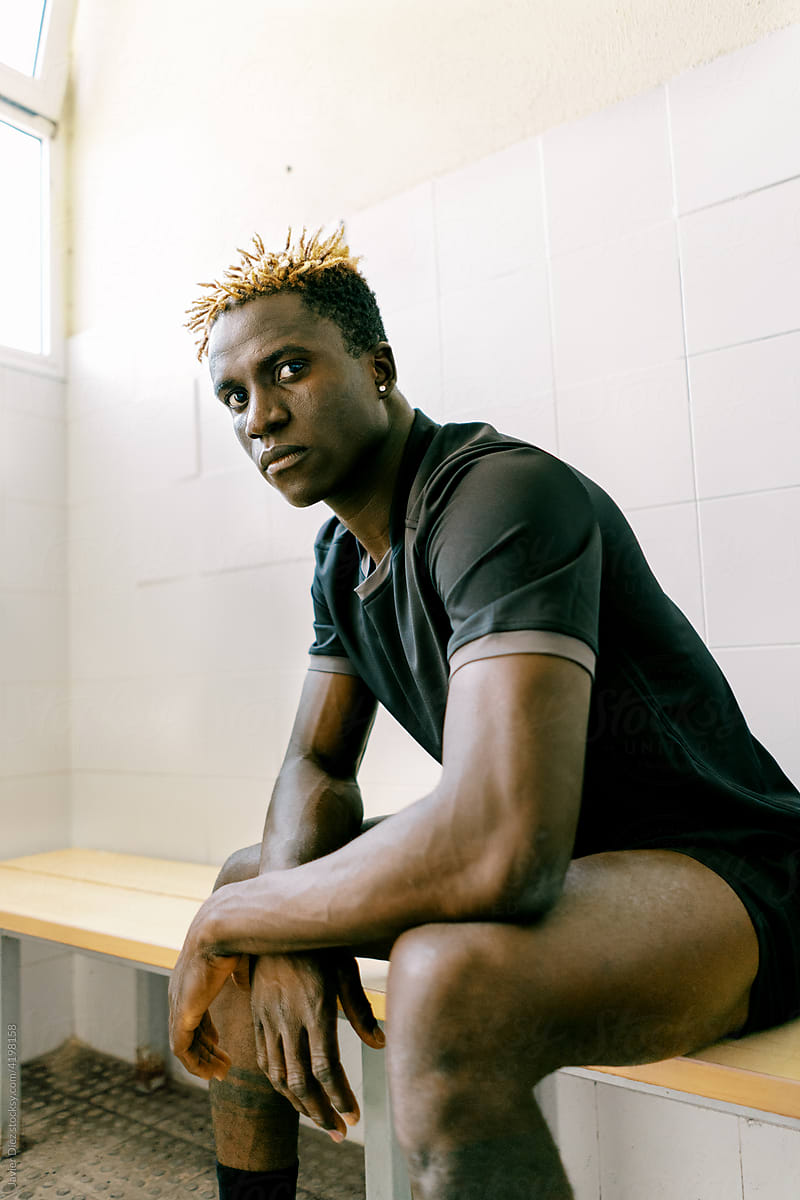 Black male footballer in changing room