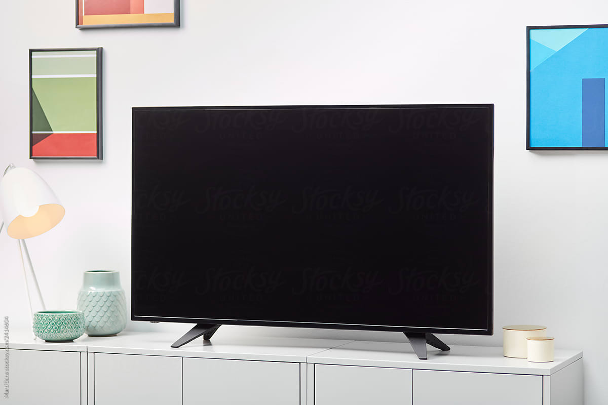 Black TV on white cabinet indoors