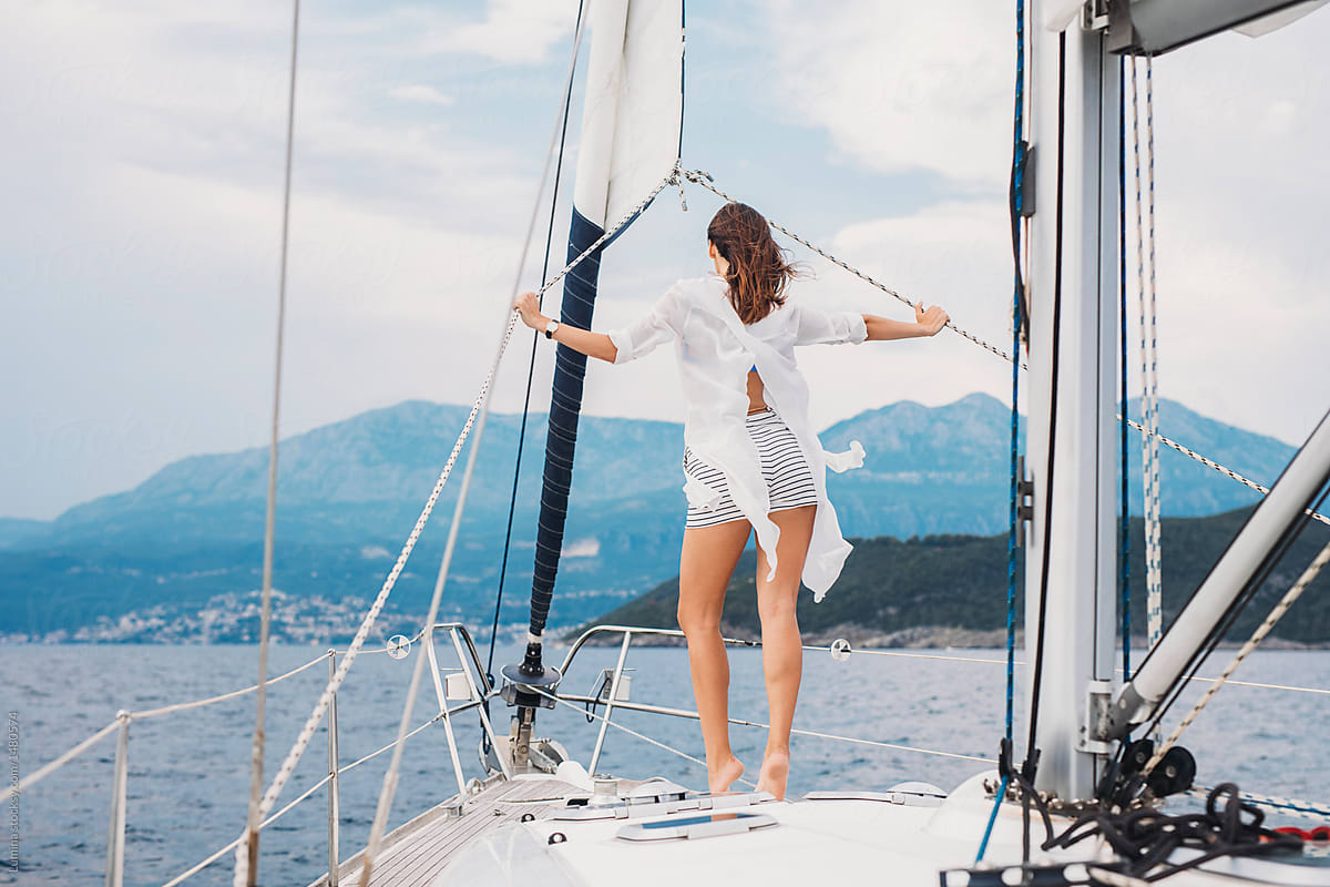 Woman Standing on Sailboat
