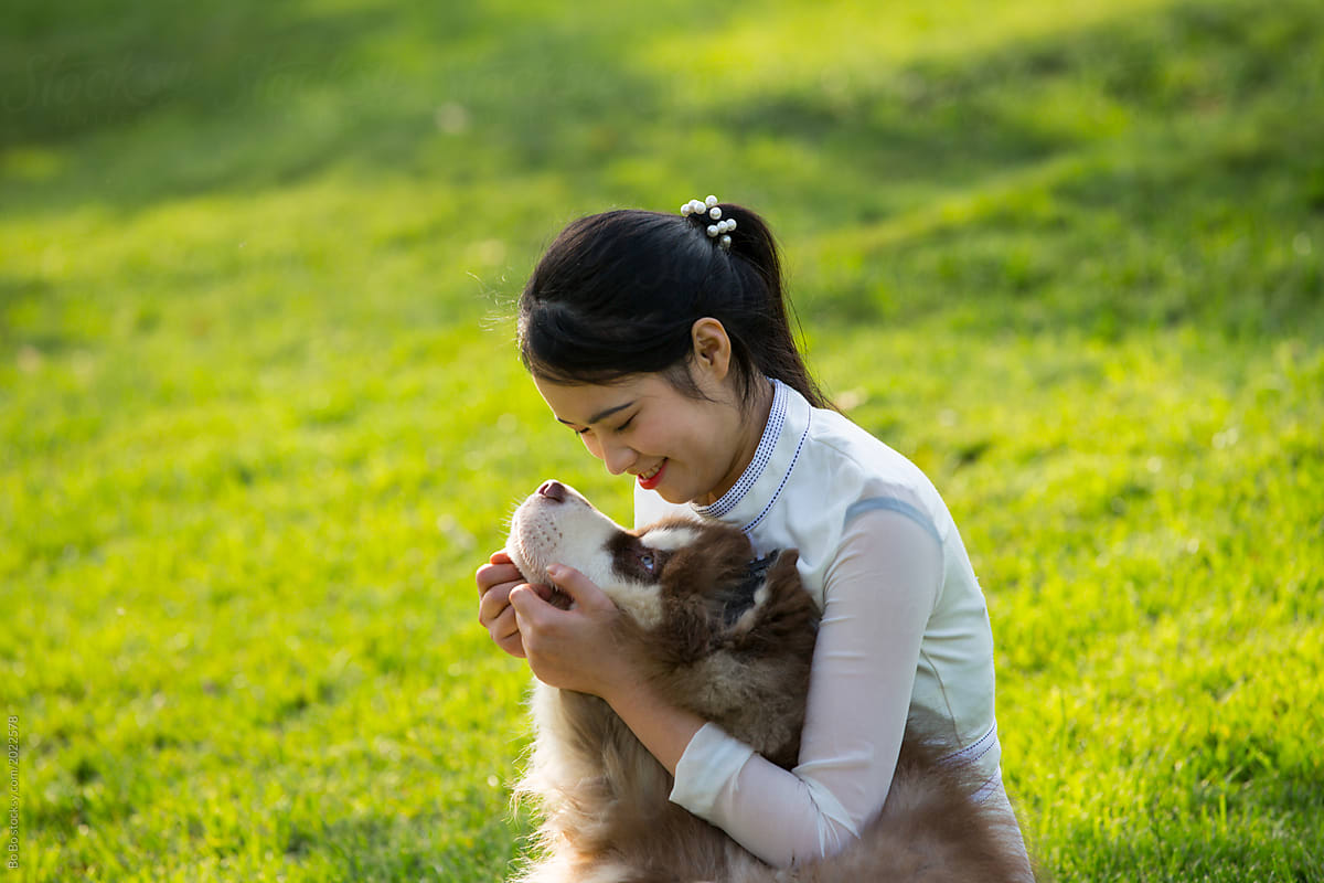 Young asian woman with little dog outdoor