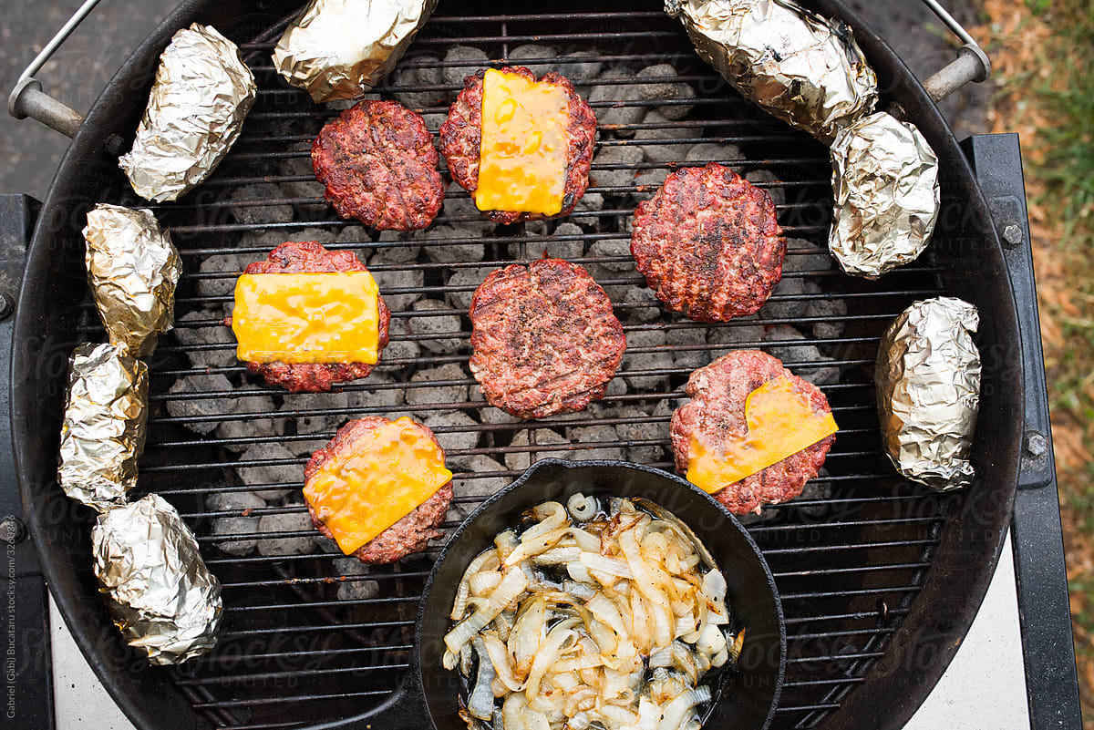 Hamburgers on a charcoal grill from overhead