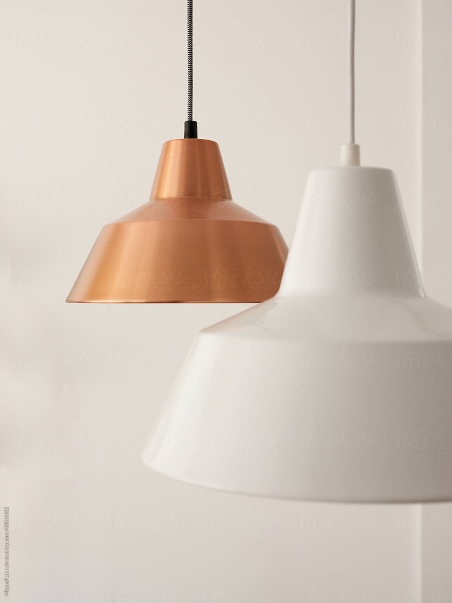 Stylish pendant lamps against white wall