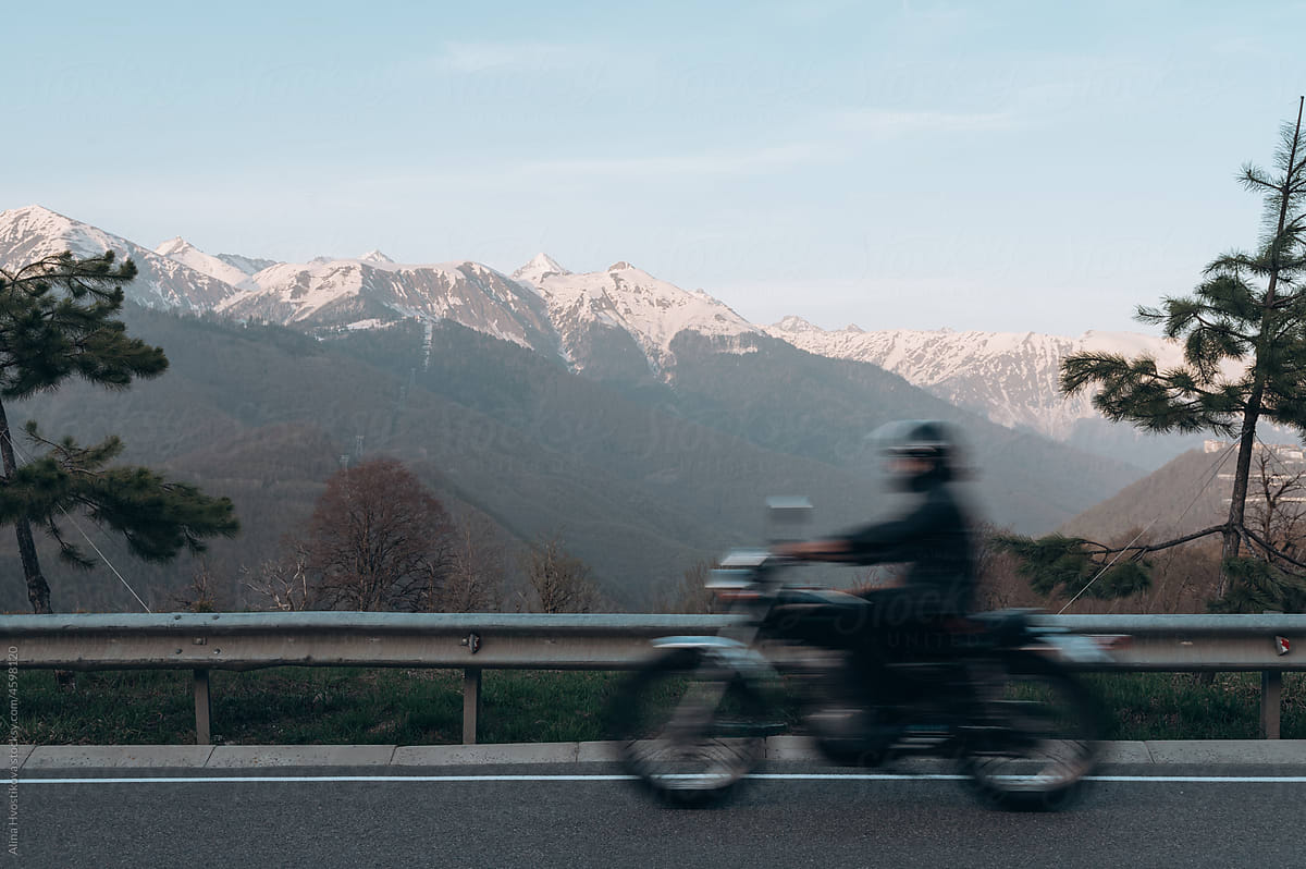 Man driving motorcycle near mountains