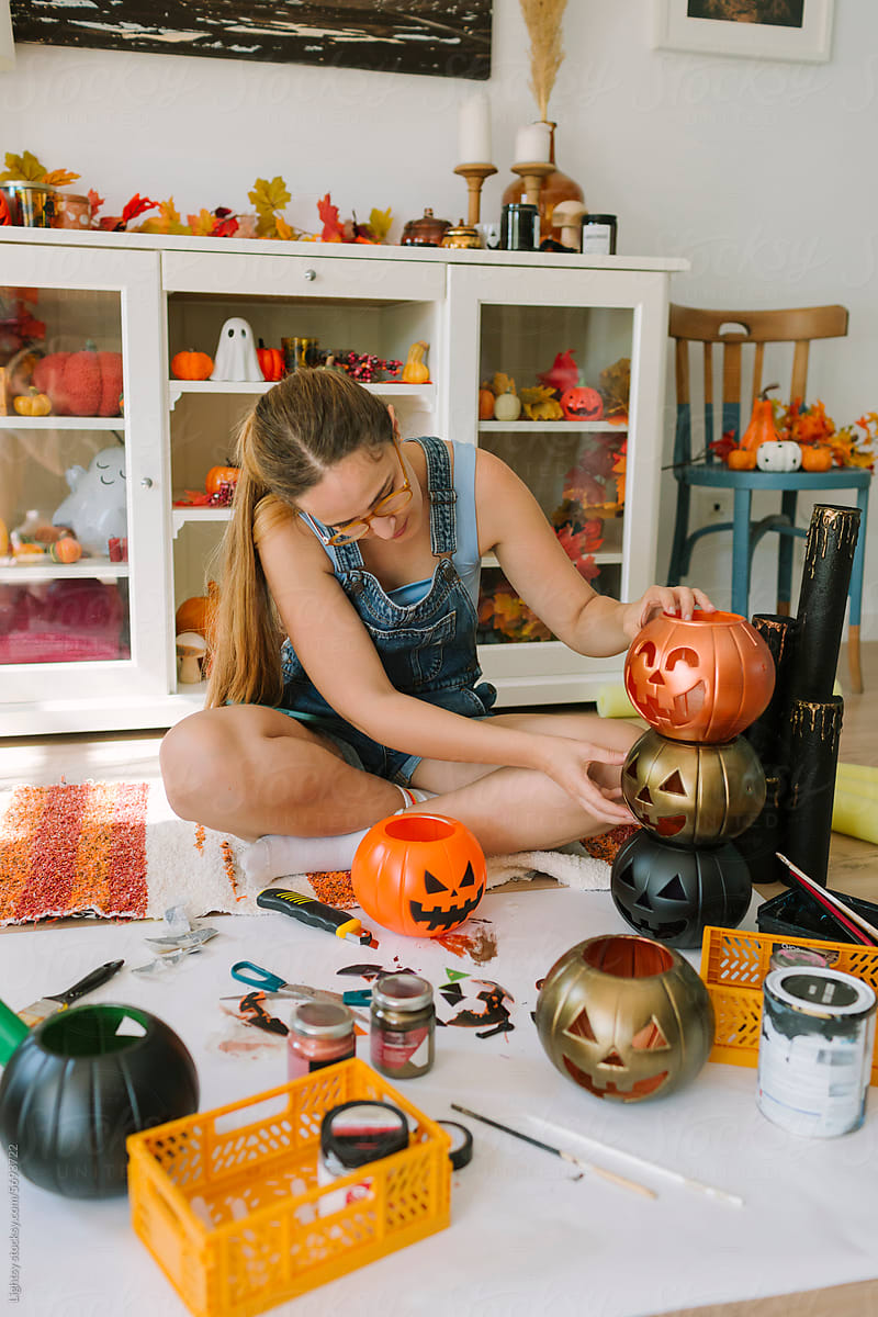 Woman doing some DIY of pumpkins for Halloween